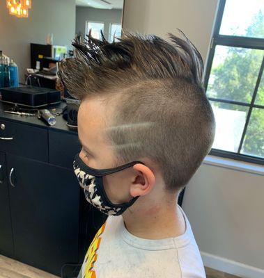 Mohawk with a hair design on the sides