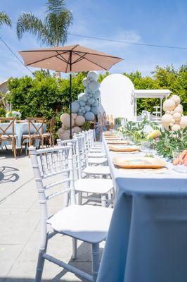 Round tables, wooden chairs, umbrella, kids tables, kids chairs, candy cart and table cloths all provided by Orchid Party Rental.