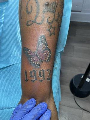 Small color butterfly on wrist tattoo