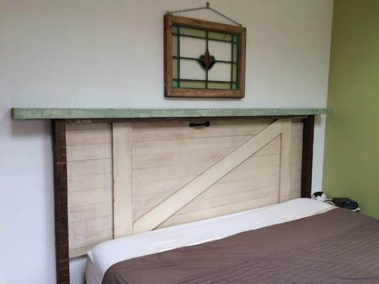 Great length of painted 2x6, old shed door, old growth 2x4s, and misc repurposed trim for a king size headboard.