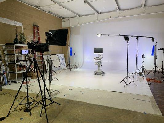 Product demonstration setup for video recording with teleprompter in studio.