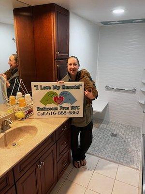 Happy customer standing next to her new shower