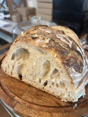 Warm fresh sourdough bread with homemade honey butter and raspberry jam