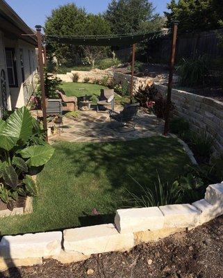 This was a project of a complete backyard transformation. We added a retaining wall, a flagstone patio, pergola, turf, and planted beds.