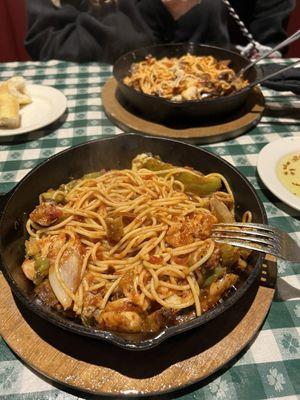 Spicy spaghetti skellitini with chicken, sausage and shrimp