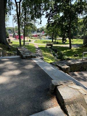 Walkway from fountain and pond to field, water pads and jungle gyms