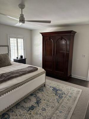 Wardrobe as a focal point hiding books and decor.