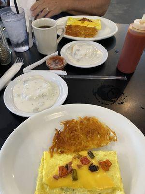 Split western omelet that comes with biscuit and gravy.