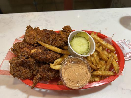 Spicy chicken tenders basket with an extra chicken strip