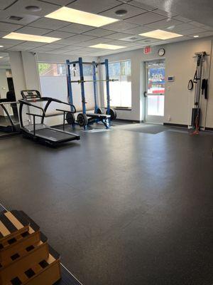 Spacious gym with squat rack