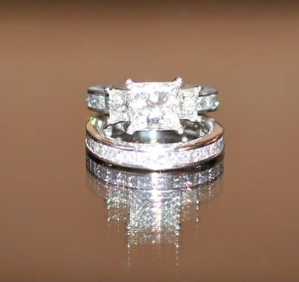 custom made:  platinum channel set princess cut 3/4 eternity bands, side stones .53 carats, center stone - use ur imagination ;)