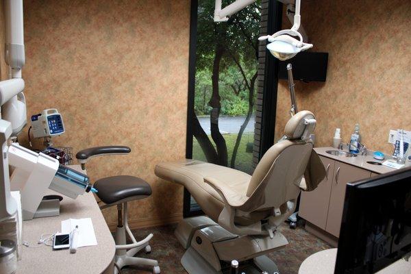 Each exam room has large windows with views of the trees and the Barton Creek Greenbelt to create a calming atmosphere.