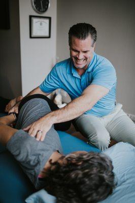 Physical Therapist administering shoulder capsule release to restore neutral shoulder joint alignment