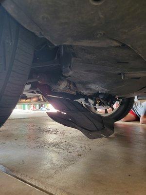 The oil pan guard removed during oil change just hanging due to tech not tighting the fasteners.