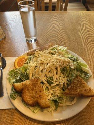 Caesar salad with shredded chicken breast.