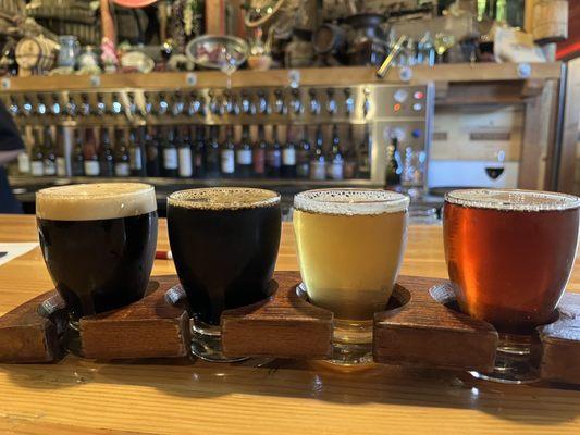 A beer flight selected from a comprehensive menu.