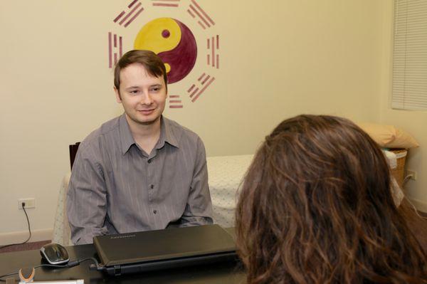 Nick Arestopoulos, LAc interviewing patient