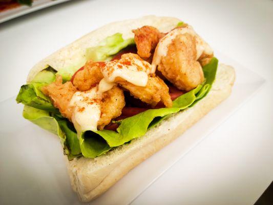 Shrimp Po Boy Sandwich - White shrimp served with onions, butter lettuce and a house made rémoulade sauce on a freshly baked baguette