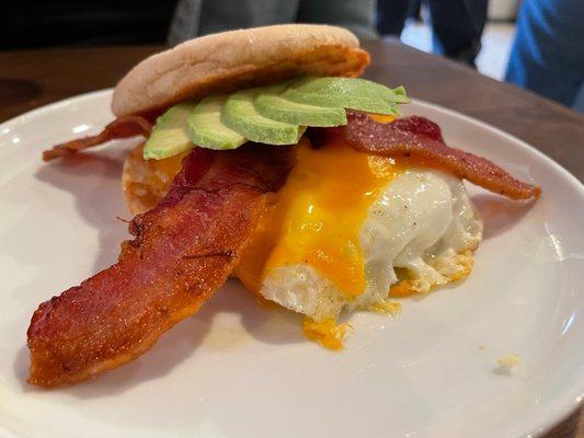 Breakfast Sandwich with Bacon, Egg, Cheese, and Avocado on an English Muffin