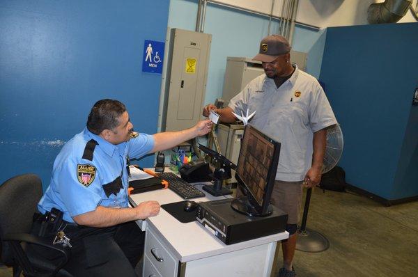 Security guard checking visitor info