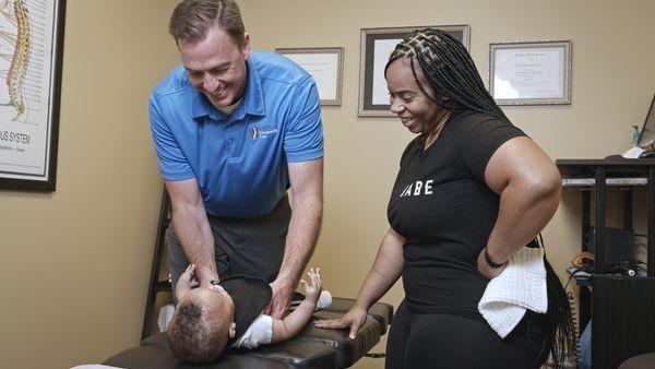 Dr. Stevens adjusting a newborn patient.