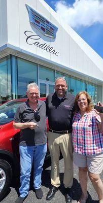 Chad in the middle. Very happy day for my husband and me celebrating our new Cadillac. Tasca Cadillac of Melbourne FL. Great experience!!