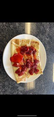 Strawberry crepes with fresh strawberries in the inside.