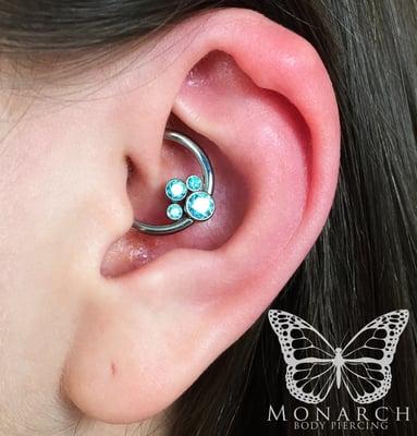 Fresh daith piercing on our friend, Charley, with a gem cluster from Anatometal