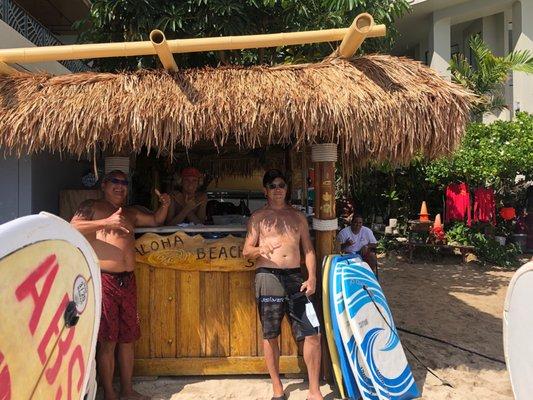 The hut with Rony to the left and me  hang loose and the rest of the crew .  Located between the Outrigger and Moana next to Dukes .