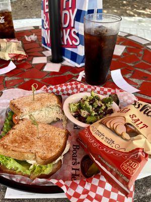 Chicken salad sandwich with chips and broccoli salad