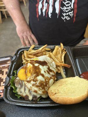 Mushroom Swiss burger with a fried egg added and fries