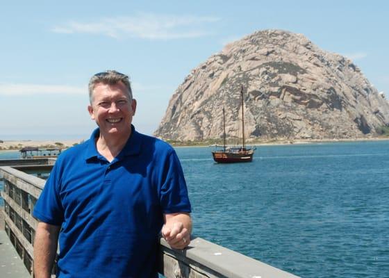 Dr. Knowles enjoys traveling with family. Here he is with a pirate ship.