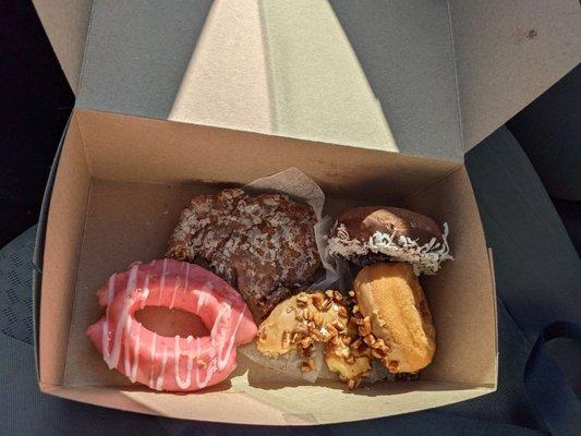 Raspberry old fashioned, maple pecan, chocolate with coconut, and an apple fritter.  Some were sampled before I took the picture.