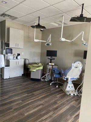 Open bay with ceiling TVs for patients