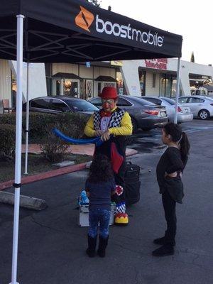 The clown doing balloon art.