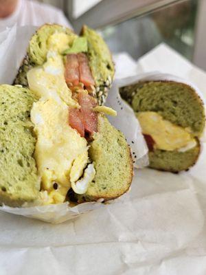 Pesto and egg breakfast sandwich on spinach everything