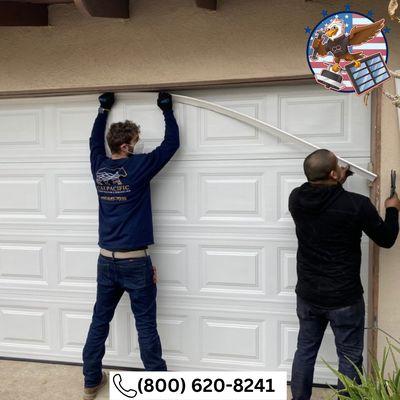 Efficient garage door installation in progress - trust the experts! Call (800) 620-8241 for professional service.