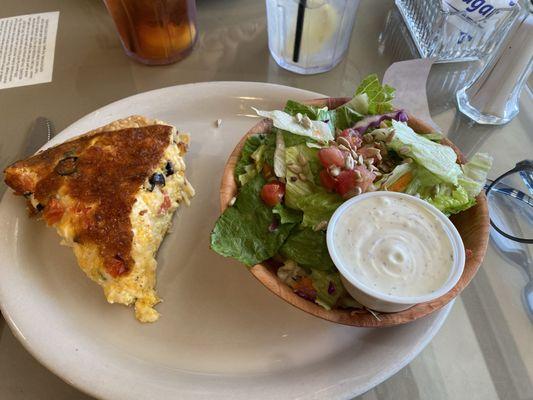 Tomato and olive quiche with a side salad.