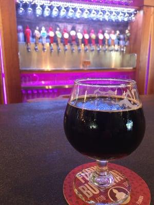 The Nikolai Vorlauf Imperial Stout. Beer taps in the background behind the bar.