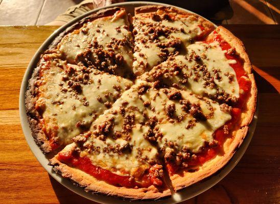 Cauliflower crust pizza with sausage and extra cheese