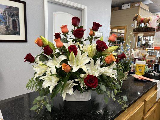 Orange with red roses and those oh so fragrant stargazer lilies