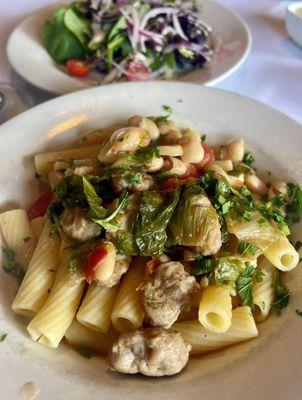 Rigatoni toss with escarole chunks of Italian sausage, white beans, and garlic and oil. Amazing.