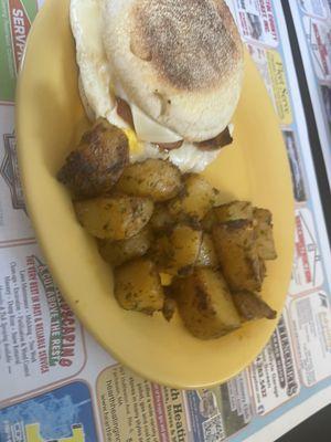 Linguica Egg And Cheese on a muffin with homefries!