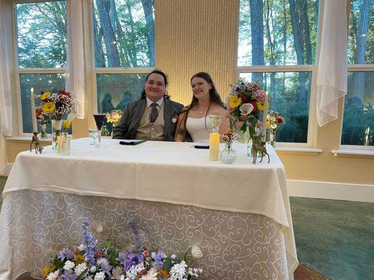 Sweetheart table with a view of the wooded gardens.