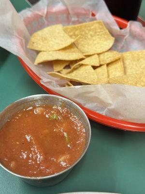 Home salsa and warm chips for waiting.