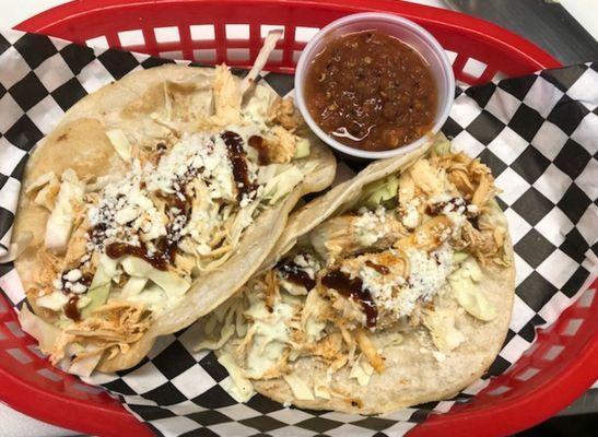 Smoked Chicken Tacos with Cabbage, Cojita cheese, avocado creama & Bbq sauce.