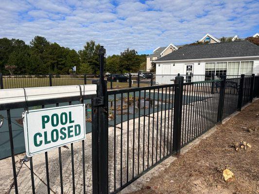 Defunct Pool Area! Notice the weeds and debris growing by the pool cover.