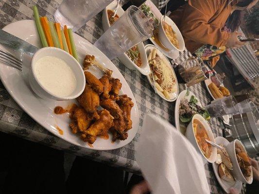 Buffalo Chicken Wings, at the end of the table oxtail Stew, and in the middle is the set up with Soup or Salad & Bread