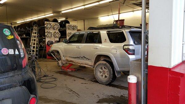 The tech was able to clean out all the bark that was wedged between the tire/rim and re-mount the tire.