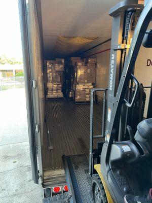 Driver unloading customers linehaul freight for sorting and same day delivery